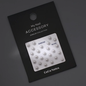 Close-up of 5D white pearl nail charms with silver metal edges in MJ-030 packaging