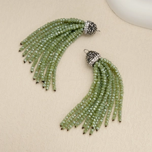 Detail of green beaded tassels with sparkling silver rhinestone caps for DIY jewelry making