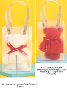 Detail of red and white bear-shaped towels in transparent PVC gift bags with handles