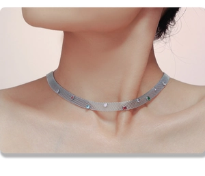 Detail of silver mesh choker necklace featuring colorful heart-shaped zircon gemstones