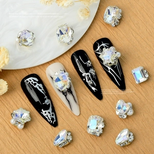 Macro shot of 3D crystal nail art charms with mixed AB rhinestones and pearls on nails