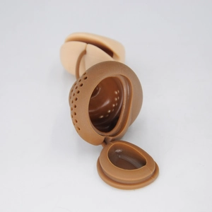 Detail of a silicone poop tea infuser showing the internal structure and filter holes