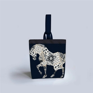 Detailed view of dark blue fabric tote bag featuring a vintage black and white horse print