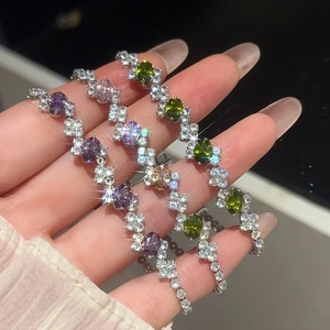 Detailed close-up of oval zircon bracelets in purple, olive green and champagne pink