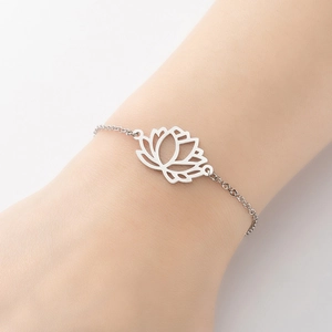 Detail of silver stainless steel lotus pendant bracelet on female model wrist