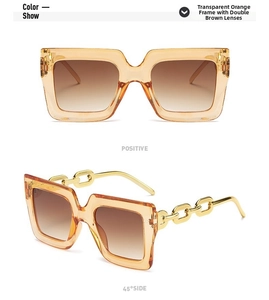 Detalle de la montura naranja extragrande con patillas de cadena dorada y lentes marrones