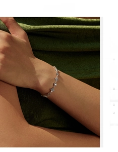 Close-up of S925 sterling silver four-leaf clover bracelet with pavé diamonds on wrist