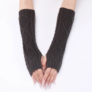 Macro detail of dark brown cable-knit arm warmers with soft wool texture on forearms