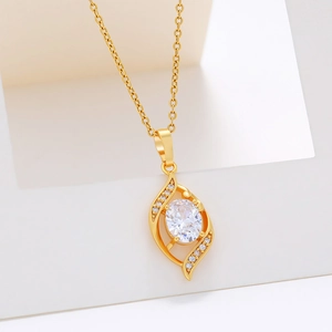 Elegant gold leaf-shaped pendant necklace with oval crystal and pavé zircon accents