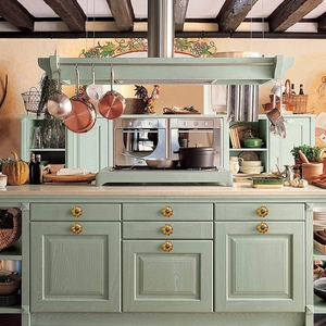 Vintage orange pumpkin ceramic knobs installed on retro green kitchen cabinet drawers