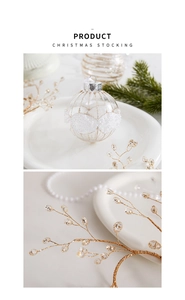 Detail of Christmas glass ball ornament with gold silk thread and white bead accents