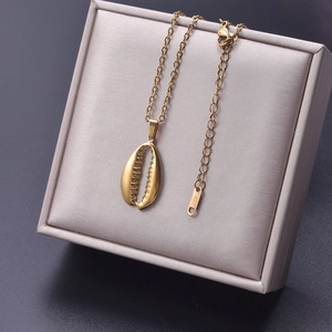 Macro shot of 18k gold plated shell pendant necklace with S.STEEL hallmark engraving