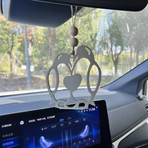 Car rearview mirror pendant featuring two wooden penguins forming a heart shape