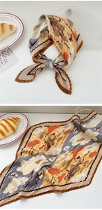 Detail of pleated silk scarf featuring retro floral patterns and scalloped brown edges