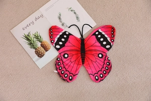 Detailed view of pink butterfly costume wings with black patterns and soft velvet center