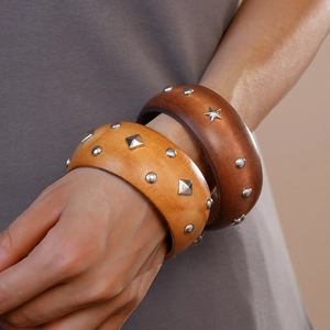 Detailed view of vintage wooden bangles with star and round metal studs decoration