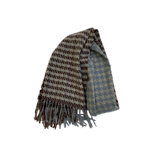 Classic brown and light blue houndstooth scarf with elegant fringes on white background