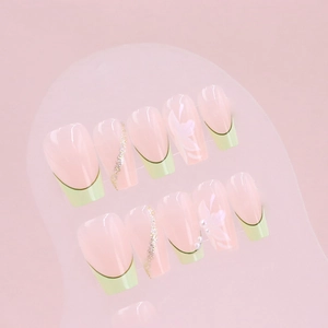 Green French tip press-on nails with white flower accents and silver glitter lines