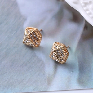 Detailed view of 3D geometric gold earrings with micro-pave crystal rhinestones