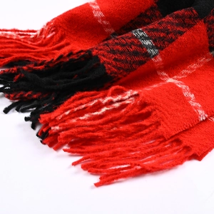 Close-up of soft red and black plaid faux cashmere scarf with detailed fringe edges
