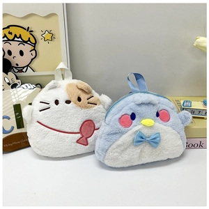 Detail view of plush cat and penguin coin purses with soft textures and cute bows