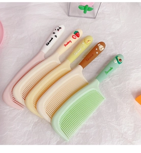 Detail view of five cartoon hair combs in pastel colors with cute 3D animal toppers