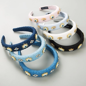 Detail of multi-color denim and velvet headbands featuring beaded Evil Eye decorations