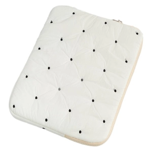 Padded off-white laptop sleeve with black quilted polka dots and metal zipper closure