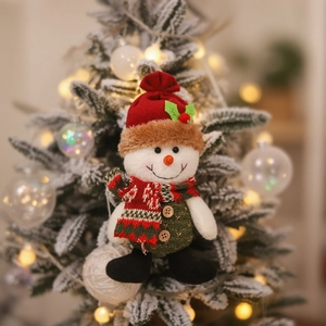 Christmas snowman plush ornament hanging on decorated tree with festive warm lighting