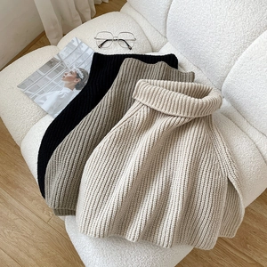Minimalist knitted turtleneck scarf in black, grey, and beige with ribbed texture