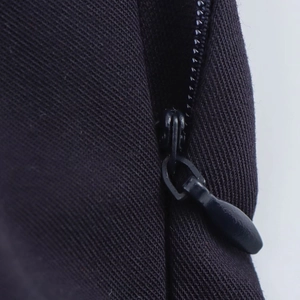 Close-up of invisible back zipper on black mini dress with high-quality twill fabric detail