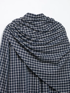 Detailed view of the blue and white plaid cotton-linen fabric with draped texture