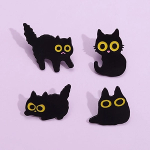 Set of four cute cartoon black cat enamel pins in various poses on a lilac background