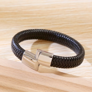 Detail shot of braided black leather bracelet with silver stainless steel magnetic clasp