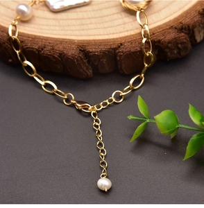 Detail of natural freshwater pearl bracelet with gold chain and lobster clasp closure
