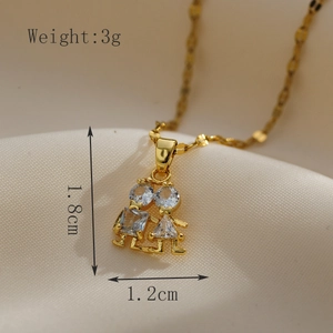 Detail shot of golden boy and girl pendant with zircon stones on silk, 1.8cm height