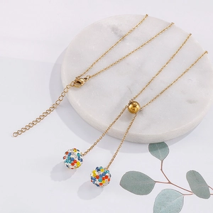 Golden stainless steel necklace with crystal-encrusted spheres and adjustable slide bead