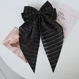 Elegant large black striped fabric bow hairclip with long ribbons on white background