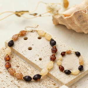 Detailed shot of ethnic resin beaded necklace and bracelet set with marble texture