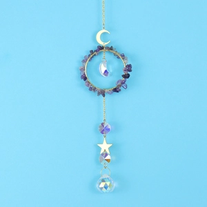 Detail of amethyst moon star suncatcher with faceted crystal ball on blue background