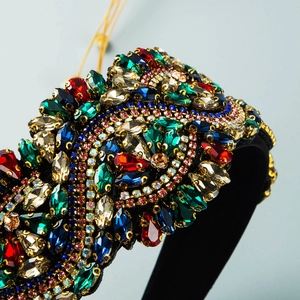 Close-up of Baroque headband with colorful rhinestones in deep blue and emerald green