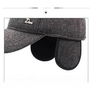 Close-up of winter wool baseball cap featuring fold-down ear flaps and metal logo