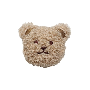 Cute brown plush teddy bear head brooch accessory with embroidered details on white background
