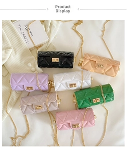 Flat lay of mini quilted jelly barrel bags in seven colors with golden chain straps
