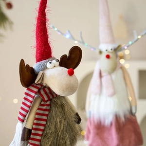 Handcrafted Christmas elk ornament with red pointed hat and striped scarf for festive decor