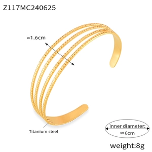 Detailed view of layered 18k gold plated titanium steel open cuff with geometric design