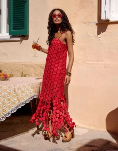 Detail of red hollow dot midi dress featuring unique textured scales and tassel fringe