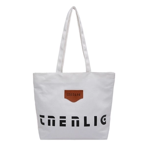 Minimalist large white canvas tote bag with black CHERLIG print and leather patch