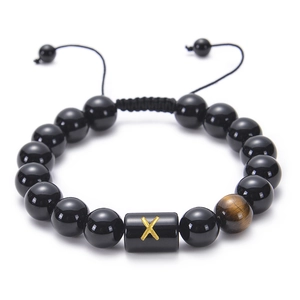 Detail of adjustable braided obsidian bracelet with tiger eye stone and golden X charm