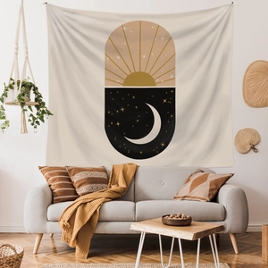 Bohemian sun and moon wall tapestry hanging above a modern living room sofa decor